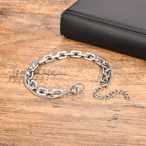 Detail of silver double-layer stainless steel chain bracelet with lobster clasp and extender