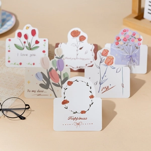 Artistic detail of assorted floral gift cards with tulip and rose designs and greetings