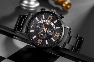 Detail of Yolako men's steel watch with black textured dial and calendar on a chessboard
