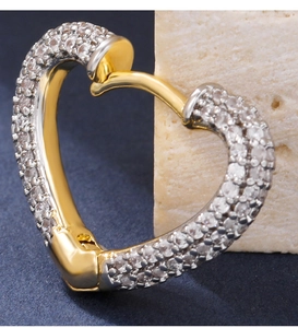Macro view of heart-shaped gold earring featuring micro-pave clear cubic zirconia stones