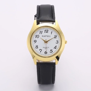 Close-up of golden quartz watch with white numeric dial and black leather strap