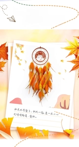 Detail of tree of life dreamcatcher with warm orange feathers and autumn leaf decor