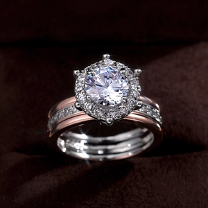 Macro detail of three-piece engagement ring set with bicolor gold and circular diamonds