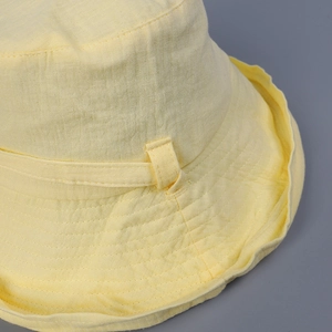Pale yellow cotton summer sun hat with wide brim and decorative ribbon detail