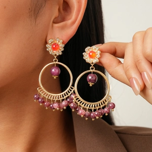 Bohemian style hoop earrings with rhinestones and orange stones on gold plating