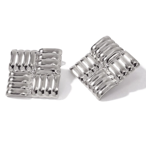 Macro detail of silver square stud earrings with 3D woven texture on 18K stainless steel