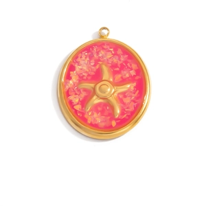 Macro view of golden circular starfish pendant with glittery magenta resin inlay