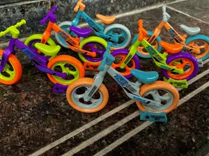 Macro detail of multi-color ABS balance bike models with SUPER SPEED racing decals