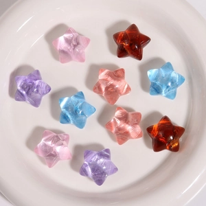 Macro shot of ten translucent resin star charms in assorted pastel colors for DIY jewelry