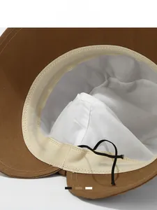 Detail of caramel bucket hat interior showing sweatband and adjustable black drawstring