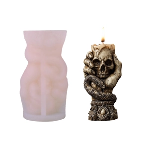 Silicone mold and gothic candle featuring skeleton hand holding skull with a snake base