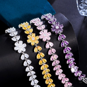 Detail of flower bracelets with pear-shaped cubic zirconia in white yellow pink and purple