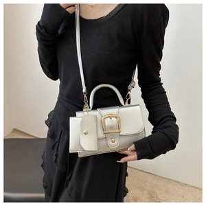 Detail of silver PU leather mini bag with gold buckle and matching small coin purse charm