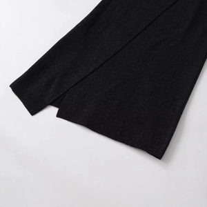 Women's black midi skirt with asymmetrical split hem and high-quality knit texture