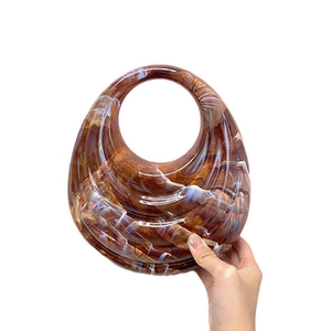 Chic amber acrylic wavy handbag with a round handle and retro resin texture