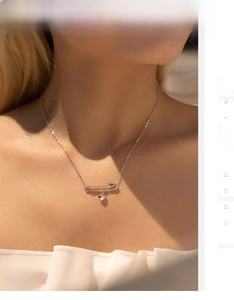 Detail of S925 silver safety pin necklace with mirror heart pendant on a model's neck