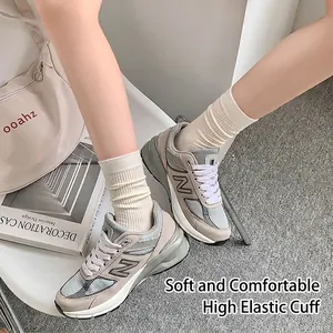 Vintage grey mesh and suede running sneakers paired with white ribbed cotton socks