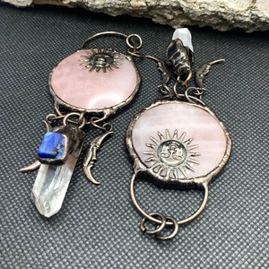 Detail of sun and moon asymmetrical earrings with pink quartz and blue gemstones