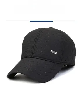 Detail of black quilted baseball cap with Sport metal badge and diamond stitching