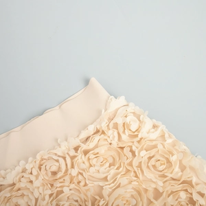 Detailed view of beige maxi skirt with 3D floral petals and elegant petal appliques