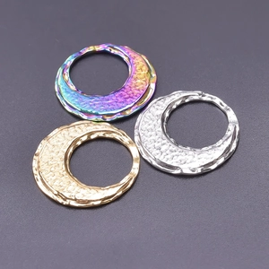 Detail of 18k gold and silver hammered texture round ring charms for DIY necklaces