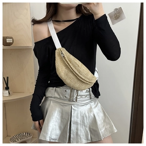 Detail of woven straw fanny pack featuring metal zipper and adjustable white strap