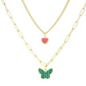 Double-layered gold necklace with green butterfly and red heart pendants on white background