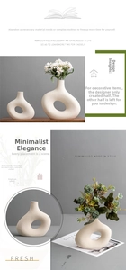 Macro shot of minimalist donut ceramic vase with matte texture and circular cutout detail