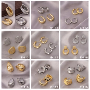 Collection of nine gold and silver earrings with zircon inlays and checkered patterns