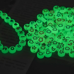 Luminous green acrylic beads with glow-in-the-dark moon and star patterns for DIY jewelry