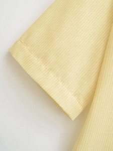 Detailed view of yellow and light blue pinstriped cuff with precision stitching
