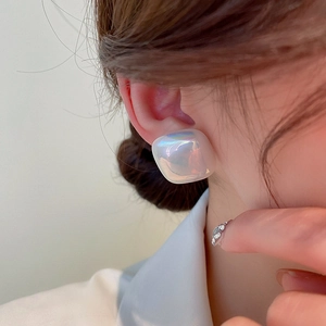 Minimalist square aurora faux pearl earrings worn by a model in a close-up profile shot