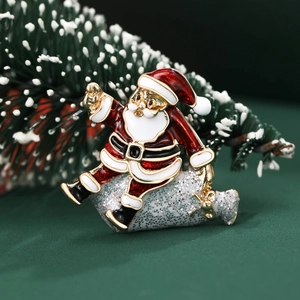 Creative enamel Santa Claus brooch with gold powder detail on festive pine background