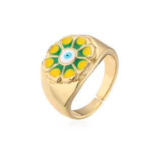 Detailed macro view of 18K gold plated sunflower ring with colorful enamel and evil eye charm