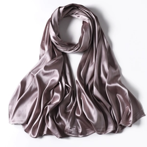 Detailed view of the smooth texture and silky luster of the dusty pink satin long scarf