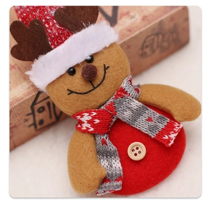 Close-up of reindeer felt pendant with knitted scarf and wooden button for Christmas tree