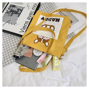 Detailed interior of a yellow canvas tote bag showing high capacity for iPad and umbrella