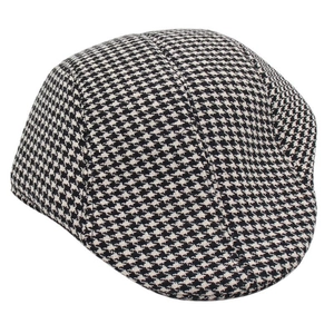 Detailed view of black and white houndstooth wool flat cap with woven texture and multi-paneling