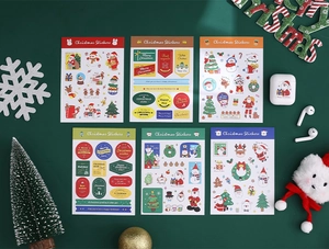 Set of six Christmas stickers featuring Santa and snowmen on a festive green background