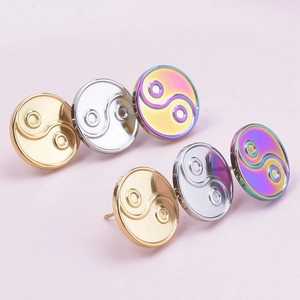 Close-up of yin yang hoop earrings in gold, silver, and rainbow vacuum plated 304 steel