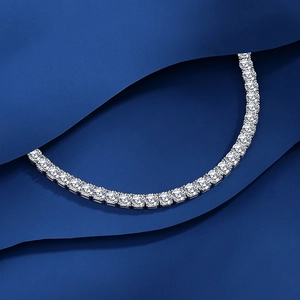 Elegant S925 sterling silver tennis bracelet with round-cut moissanite stones on blue fabric
