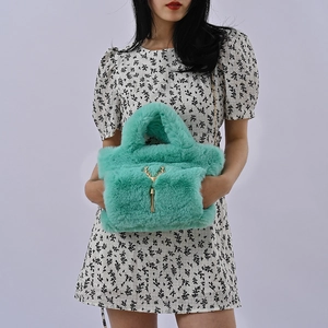 Mint green faux fur handbag with golden deer charm and hand warmer pocket for women