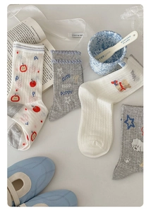 Detail of grey cotton mesh crew socks featuring cute cartoon dog and apple patterns