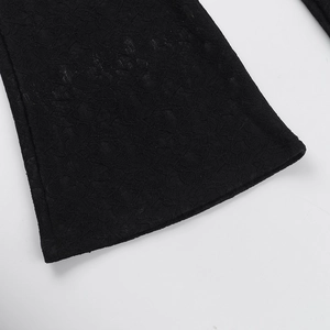 Close-up of intricate black lace floral patterns and delicate stitching details on fabric
