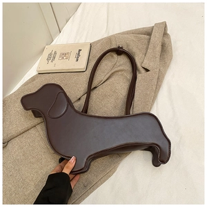 Detail of dachshund-shaped leather shoulder bag in dark brown with matte finish
