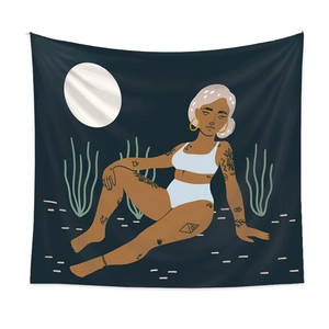 Detail view of Bohemian tapestry featuring a tattooed woman under a white moonlit night sky