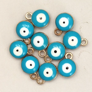Macro view of 8mm double-sided blue evil eye enamel charms with gold edges for jewelry making