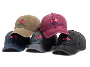 Close-up of flamingo embroidery on various colors of washed cotton baseball caps