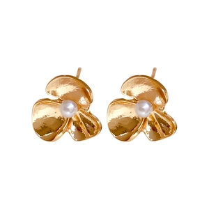 Elegant gold flower pearl stud earrings with textured metallic finish on white background