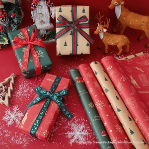 Detail of Christmas ribbons and gift boxes featuring gold reindeer and snowflake patterns
